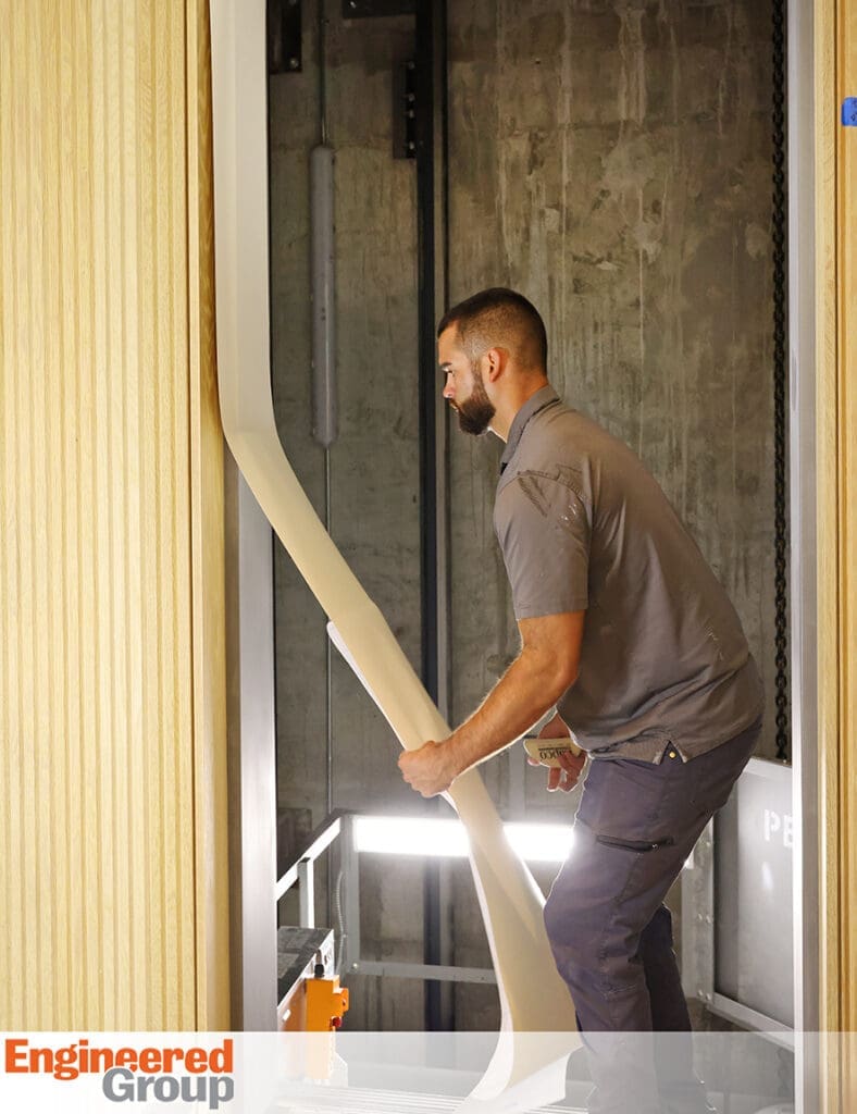 Engineered Group applying woodgrain architectural film